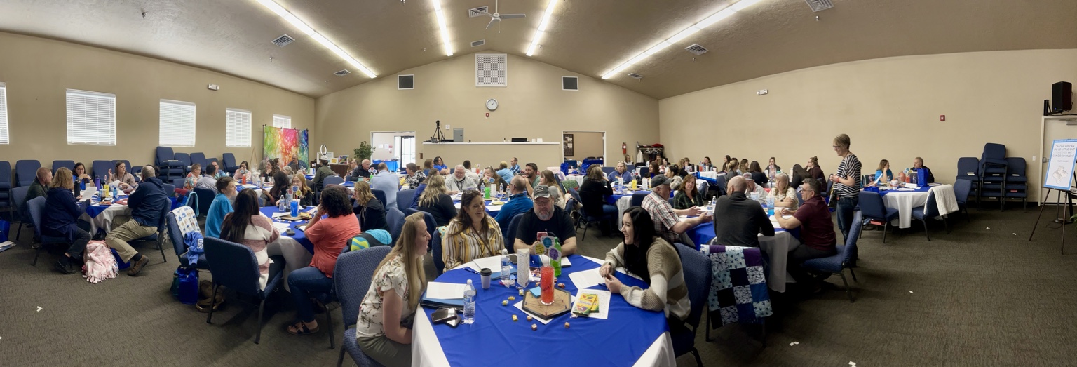 A large FRTC training event with participants working together at tables