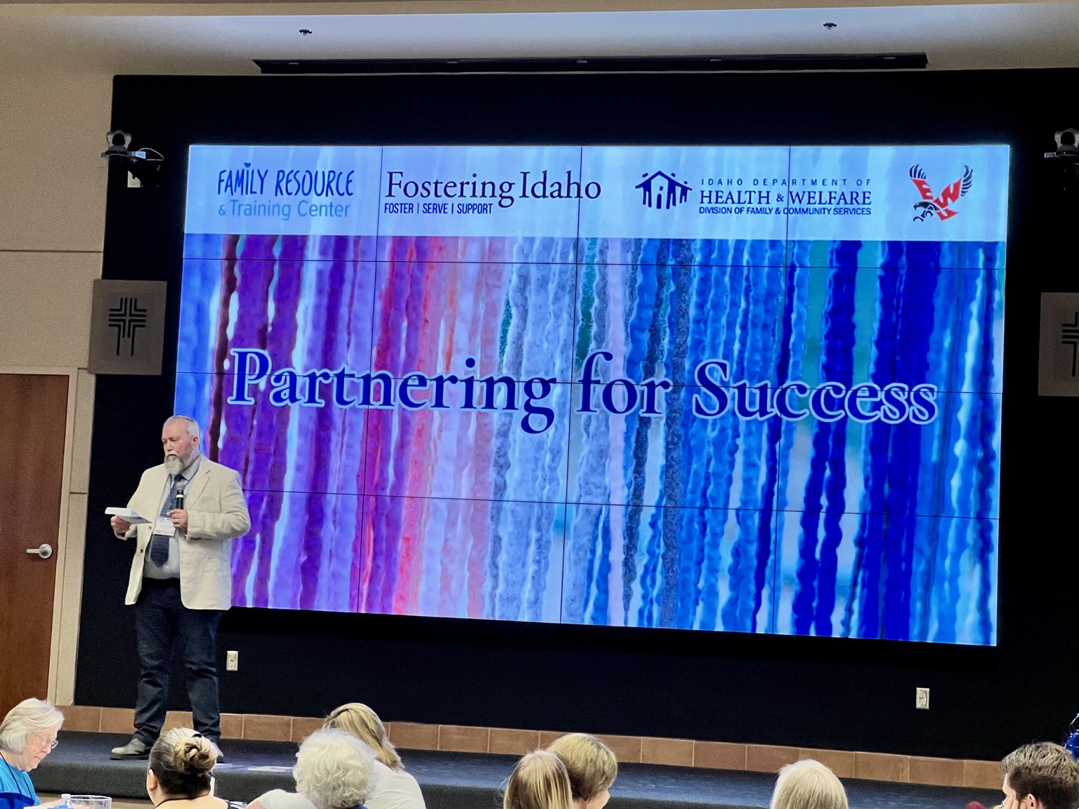 FRTC conference presentation with Partnering for Success displayed behind the speaker